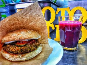 Falafel burger and freshly squeezed orange/pomegranate juice. at Vegan 365 Kitchen in Skopje