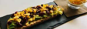 Nashville avocado toast with red beans, sweet corn, red onion, nacho chips and red hot chili pepper at R&B Cafe in Ljubljana
