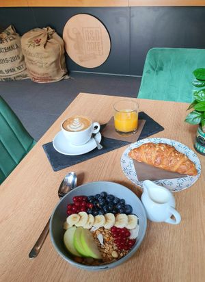 Granola bowl topped with seasonal fruits at R&B Cafe in Ljubljana