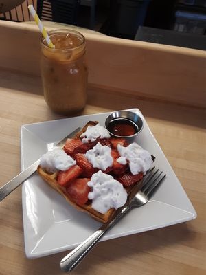Cold Brew w/ a splash of oat milk, House-made Waffle, w/ coconut whip, (+$1) strawberries, + a side of organic maple syrup at Amateur Coffee in Omaha