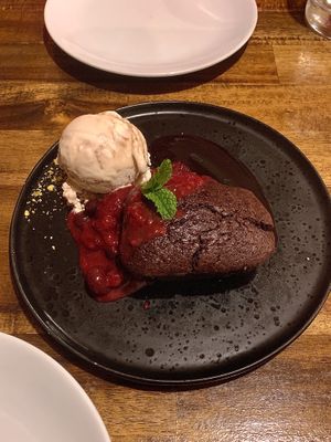Warm brownie with red wine compote and nutty ice cream   at Polpetta in New Plymouth