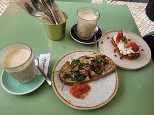 Toast with mushrooms, spinach, and hummus and chai lattes (also pictured is gf carrot cake that is not vegan) at Nicolau Lisboa in Lisbon