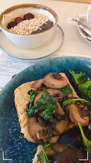 Part of the vegan Brunch: bread with hummus, mushrooms and spinach and a creamy Avocado Smoothie Bowl at Frutaria in Lisbon