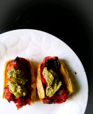 Roasted Ripe Plantain Boats Stuffed with Roasted Tomatoes and Topped with a Walnut Pesto at Zoleah Cafe in Kingston