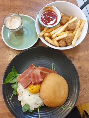 Popcorn chikn + chips $10.00; Bacon and egg roll $20.00 (the white fried egg part was soo similar to the real thing, the yolk was bland, needs black salt) at One for the Crow in Maidstone