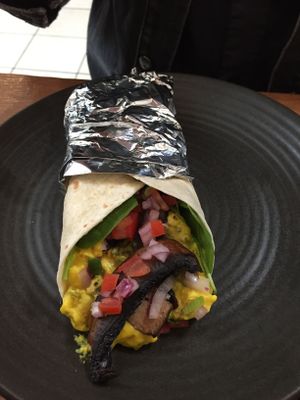 Vegan breakfast burrito (special) with cheesy jalapeño tofu scramble and veggies at One for the Crow in Maidstone