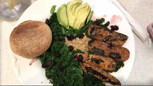 Vegan tempeh buddha bowl with brown rice, kale, avacado, dried fruit and an English muffin at Anna's House - E Beltline in Grand Rapids