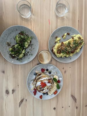 Avo toast, tofu/bacon scramble, classic American pancakes, oat milk latte at Jord in Malmo