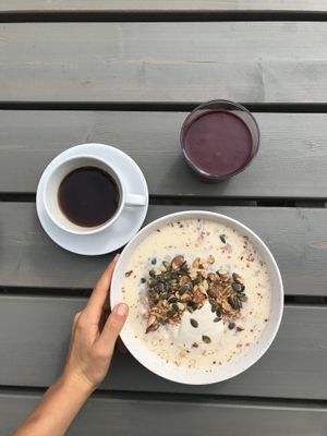 Millet porridge with stewed rhubarb compote and a mixed berry smoothie, both delicious! at Jord in Malmo