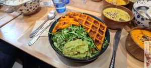 "Gaufre de Patate Douce" sweet potato paste, coconut milk & turmeric on a bed of arugula & oak leaves, fresh guacamole, pomegranate seeds, homemade mustard vinaigrette at Riz Riz - Marais in Paris