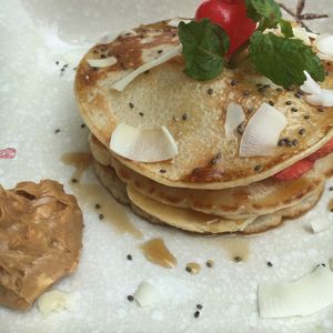 Pancake + banana + strawberry + maple syrup + peanut butter on side at The Fisherman Vegan Restaurant   in Hoi An