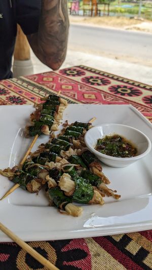 Beef and enoki skewers wrapped in lolot leaf at Phong Nha Vegan in Phong Nha