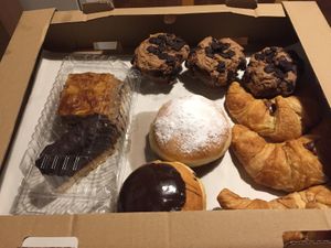 my tray of vegan goodies including choclate brownies, doughnuts, croissants, and decadent cakes. at PiranArt Sameja in Ljubljana