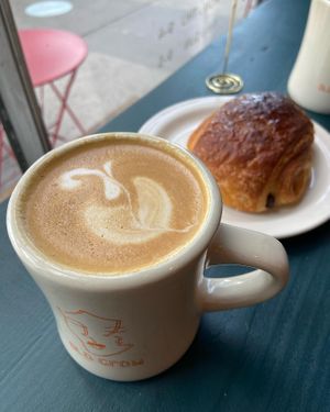 Latte with oat milk and vegan pain au chocolate   at Old Crow Coffee Co. & Moodswing Coffee in New Westminster