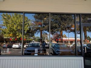 Dark front glass of the restaurant at Merit Vegan Restaurant in Sunnyvale