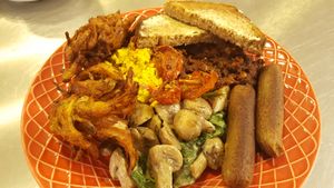 The Roots Breakfast.  Badass.  100% Vegan.  Sage & Marjoram Sausages, Coriander Pakora, Scrambled Spiced Tofu, Smokey Beans, Mushroom Spinach and Coconut Cream, Roast Tomato and Toast  at Roots Lounge in Bristol
