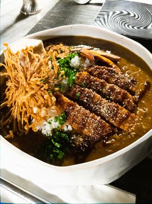 Katsu with curry sauce on a bed of rice topped with fried enoki mushrooms.  at Monk's Butcher - Itaewon in Seoul