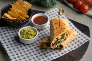 Kale & Mushroom Wrap with hummus, black olives, artichoke, dried tomatoes & house dip at Café 302 in Abu Dhabi