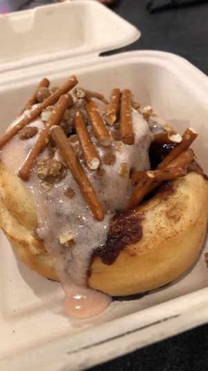 Roll with Strawberry Frosting, Pie Crumble, & Pretzel Sticks  at Cinnaholic in Boca Raton