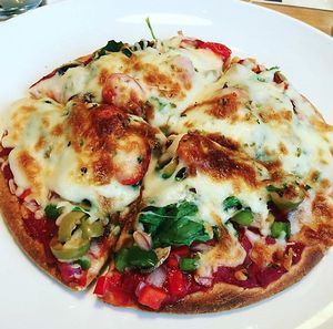 Vegan, glutenfree pizza with spinach and beans. at Wheat's End Cafe in Chicago