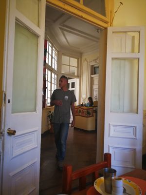 The restaurant is on the first floor of an old building with heigh ceilings and doors at Govindas Hare Krishna in Valparaiso