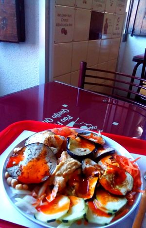 Grilled eggplant, hummus, chickpeas and salad with spicy sauce at Pao Pao Queijo Queijo in Lisbon