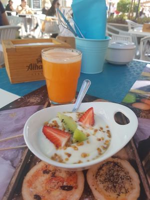 Yoghurt and fresh pressed juice as a starter of the brunch. at Plan Bakery Cafe in Tenerife