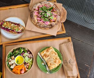 Hot dog, pizza, salad bowl and burek at Kucha in Ljubljana