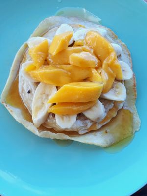vegan pancakes with banana, mango and syrup  at Freediving Planet  in Moalboal