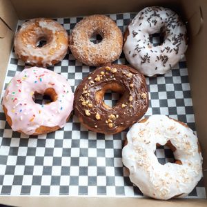 Vegan donuts! We got one of each flavor they had...sour cream glazed, cinnamon sugar, vanilla icing with chocolate sprinkles, tutti frutti with rainbow sprinkles, chocolate with walnuts, and toasted coconut. at V Food Spot in London