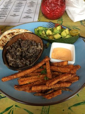 Black bean burrito, avocado, sweet potato french fries. at Toko Trash in Rotterdam
