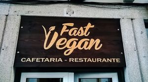 Wood logo at door. at Fast Vegan in Castelo Branco