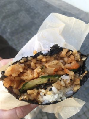 Bite through the wrap with kimchi, tofu and veg at Onigirazu in Prague