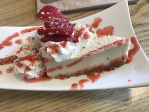 cheesecake with fresh strawberries and fresh drizzle at Love Cafe  in Oakhurst