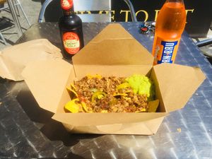 Nachos with melted cheese, guacamole, jalapeños and salsa with haggis topping at The Glasvegan in Glasgow
