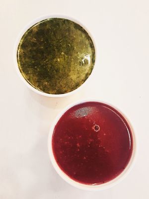 Cold cucumber and dill soup on top, red onion and cowberry soup on the bottom at Matrjoska Kroshka in Budapest