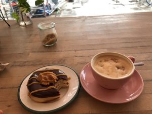 Peanut Fudge Donut and Cappucino  at Brammibal's Donuts - Prenzlauer Berg in Berlin