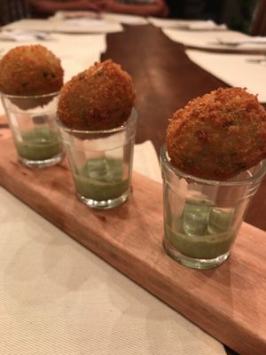 “Pérola da Yby” - Fried manioc balls filled with corn purée and served with herbal cream at Piccoli Cucina in Sao Paulo