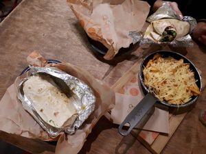 Fried risotto balls, mushrooms and veg in wraps and a side of cheesy chips. at Arancini Brothers in North London