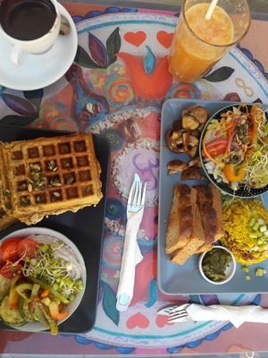savory carrot waffles with a hummus salad and tofu scrambled eggs with mushrooms and pesto at Bez Lukru in Wroclaw