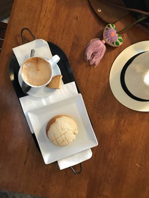 Latte with Macadamia mylk and a vegan concha  at Basic Foodie in Playa Del Carmen