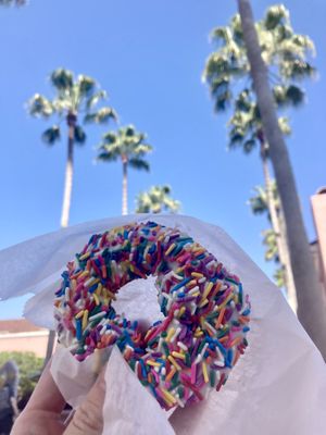 Vegan vanilla & sprinkle cake donut. SO GOOD! 😍🎉  at Universal Studios - Voodoo Doughnut in Orlando