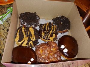Dirt (cookies and cream), ODB (cookies with peanut butter drizzle), Portland Creme (like a boston creme) and apple fritter. at Universal Studios - Voodoo Doughnut in Orlando