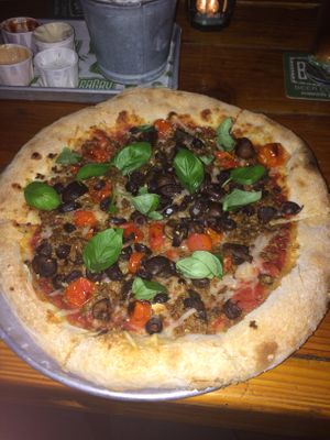 Vegan pizza with cheese, mushrooms, olives, tomato, meat replacement and basil at Bagby Beer Company in Oceanside