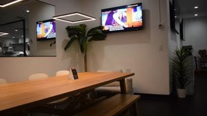 Large table sitting area with tv at The Modern Vegan in Las Vegas