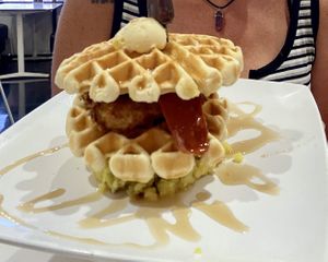 Chicken & waffles served over mashed potatoes. The size of a birthday cake 😱 at The Modern Vegan in Las Vegas