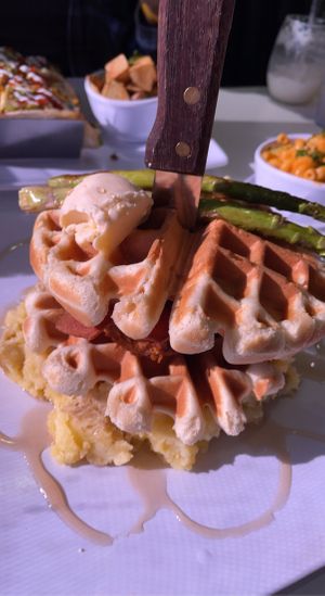 Chicken and Waffles, tacos and Mac and cheese in the background  at The Modern Vegan in Las Vegas