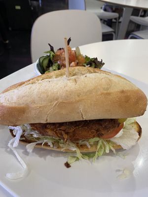 Spicy crispy chicken sandwich with side salad  at The Modern Vegan in Las Vegas