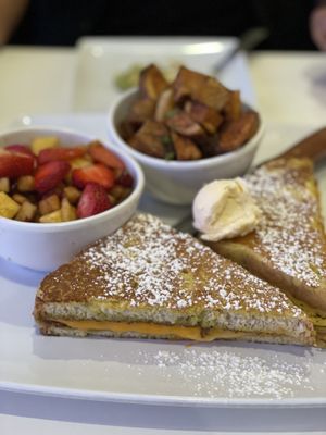 French Toast grilled cheese w bacon and pesto, fresh fruit w cinnamon, breakfast potatoes. 💯 vegan 🙏🏼  at The Modern Vegan in Las Vegas