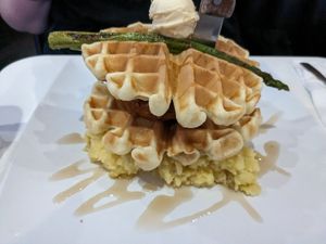 Chicken and waffles with bacon, asparagus on a bed of mashed potatoes at The Modern Vegan in Las Vegas